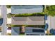 An aerial view of neighborhood homes shows the roofing, tree coverage, and spacing of the properties at 12520 Shimmering Oak Cir, Venice, FL 34293
