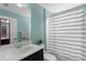 Clean bathroom features a vanity with mirror and a shower/tub with a striped curtain at 12520 Shimmering Oak Cir, Venice, FL 34293