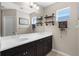 Bathroom featuring a dual sink vanity, and decorative shelving at 12520 Shimmering Oak Cir, Venice, FL 34293