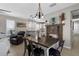 Bright dining area showcasing a rustic table, modern lighting, and an open view of the kitchen and living area at 12520 Shimmering Oak Cir, Venice, FL 34293