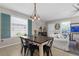 Cozy dining area featuring a rustic table, modern light fixture, and coastal-inspired decor at 12520 Shimmering Oak Cir, Venice, FL 34293