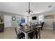 Open-concept dining area showcasing a wooden table, modern light fixture, and seamless transition to the living space at 12520 Shimmering Oak Cir, Venice, FL 34293