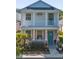 Charming two-story home with a welcoming front porch, coastal decor, and lush landscaping at 12520 Shimmering Oak Cir, Venice, FL 34293