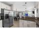Open concept kitchen with granite countertops overlooking living and dining areas at 12520 Shimmering Oak Cir, Venice, FL 34293
