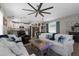 Bright living area with comfortable seating, a unique coffee table, and an open layout to the kitchen at 12520 Shimmering Oak Cir, Venice, FL 34293