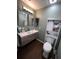 This bathroom features a floating vanity, wood-look tile flooring, and a toilet with built-in storage at 14432 Mcclellan Ave, Port Charlotte, FL 33953