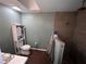 Neutral bathroom featuring wood-look tile, toilet with storage cabinet, and a tile shower stall with multiple showerheads at 14432 Mcclellan Ave, Port Charlotte, FL 33953