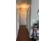 Well-lit hallway with wood-look floors leading to the front door and featuring closet space at 14432 Mcclellan Ave, Port Charlotte, FL 33953