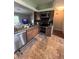 Well-equipped kitchen with stainless steel appliances, tiled floors, granite countertops, and wooden cabinets at 14432 Mcclellan Ave, Port Charlotte, FL 33953