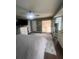Main bedroom featuring neutral paint, modern ceiling fan, and view to a private lanai at 14432 Mcclellan Ave, Port Charlotte, FL 33953