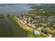Aerial showcasing waterfront condos with private boat docks, manicured landscaping, and community pool at 1609 Bayhouse Point Dr # 232, Sarasota, FL 34231