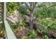 Lush backyard with mature trees, landscape, and a charming garden at 1609 Bayhouse Point Dr # 232, Sarasota, FL 34231
