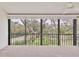 Balcony with railing overlooking a landscape with tropical trees at 1609 Bayhouse Point Dr # 232, Sarasota, FL 34231