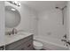 Cozy white-tiled bathroom with a modern vanity and shower-tub combo at 1609 Bayhouse Point Dr # 232, Sarasota, FL 34231