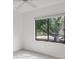 Bright bedroom featuring a ceiling fan and a large window with natural light at 1609 Bayhouse Point Dr # 232, Sarasota, FL 34231