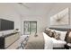 Bedroom showcasing a large bed, TV, modern artwork, and sliding glass doors with a view to the outside at 1609 Bayhouse Point Dr # 232, Sarasota, FL 34231