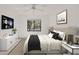 Bedroom featuring neutral decor, ceiling fan, window, and a Samsung Smart TV mounted on the wall at 1609 Bayhouse Point Dr # 232, Sarasota, FL 34231