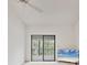 Clean bedroom space with a ceiling fan, sliding glass doors to balcony, and a flatscreen television at 1609 Bayhouse Point Dr # 232, Sarasota, FL 34231