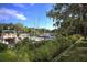 Scenic marina with boats docked, lush landscaping, and blue sky at 1609 Bayhouse Point Dr # 232, Sarasota, FL 34231