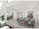 Bright dining room featuring contemporary decor, elegant table setting, and a large mirrored wall enhancing the space at 1609 Bayhouse Point Dr # 232, Sarasota, FL 34231