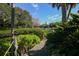 Picturesque dock with verdant landscaping leading to a serene waterfront at 1609 Bayhouse Point Dr # 232, Sarasota, FL 34231