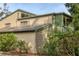 Two-story home featuring a lattice balcony, neutral-toned exterior, and lush greenery for added privacy at 1609 Bayhouse Point Dr # 232, Sarasota, FL 34231