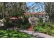 Charming two-story home with a red tile roof, surrounded by mature trees and lush landscaping at 1609 Bayhouse Point Dr # 232, Sarasota, FL 34231