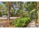 Well-manicured front yard with vibrant landscaping, a walkway, and plenty of parking spaces at 1609 Bayhouse Point Dr # 232, Sarasota, FL 34231