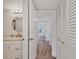 Hallway featuring a wood floor and view to bathroom at 1609 Bayhouse Point Dr # 232, Sarasota, FL 34231