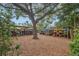 Storage racks with colorful kayaks under a large shade tree create a whimsical and practical outdoor space at 1609 Bayhouse Point Dr # 232, Sarasota, FL 34231