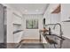 Modern kitchen with stainless steel appliances, granite countertops, and natural light from the window at 1609 Bayhouse Point Dr # 232, Sarasota, FL 34231