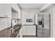 Bright kitchen featuring stainless steel appliances, dark countertops, and white cabinets at 1609 Bayhouse Point Dr # 232, Sarasota, FL 34231