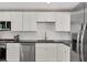 Updated kitchen with stainless steel appliances, granite countertops, and white cabinets at 1609 Bayhouse Point Dr # 232, Sarasota, FL 34231
