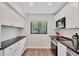 Bright and well-equipped kitchen with white cabinetry, granite counters, and stainless steel appliances at 1609 Bayhouse Point Dr # 232, Sarasota, FL 34231