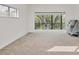 Spacious living room filled with natural light, neutral-toned carpet, and a scenic outdoor view at 1609 Bayhouse Point Dr # 232, Sarasota, FL 34231