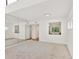 Bright, open living room featuring neutral carpet, and a wall mirror for added depth at 1609 Bayhouse Point Dr # 232, Sarasota, FL 34231