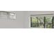 Bright living room with large windows overlooking serene green scenery at 1609 Bayhouse Point Dr # 232, Sarasota, FL 34231