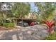 Covered parking area for multiple vehicles with a nicely landscaped entrance at 1609 Bayhouse Point Dr # 232, Sarasota, FL 34231