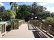 Scenic bridge leading to a pool area, surrounded by lush landscaping, perfect for relaxation and recreation at 1609 Bayhouse Point Dr # 232, Sarasota, FL 34231