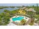Aerial view shows a lovely community pool and a nearby waterfront at 1609 Bayhouse Point Dr # 232, Sarasota, FL 34231