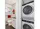 Bathroom featuring a white vanity, glass enclosed shower and a stacked washer and dryer at 174 Golden Gate Pt # 21, Sarasota, FL 34236