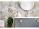 Stylish bathroom vanity with gold hardware and tropical wallpaper, creating a spa-like atmosphere at 174 Golden Gate Pt # 21, Sarasota, FL 34236