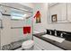 Modern bathroom with black granite sink, white tile, and glass shower at 174 Golden Gate Pt # 21, Sarasota, FL 34236