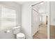 Clean, well-lit bathroom with toilet and access to the bedroom at 174 Golden Gate Pt # 21, Sarasota, FL 34236