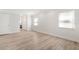Bright, spacious bedroom features wood-look floors, white walls and trim, and access to an ensuite bathroom at 174 Golden Gate Pt # 21, Sarasota, FL 34236