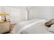 Bedroom with wood-look floors, white walls, and vintage end tables at 174 Golden Gate Pt # 21, Sarasota, FL 34236