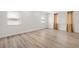 Empty bedroom with two windows and wood-look flooring at 174 Golden Gate Pt # 21, Sarasota, FL 34236