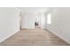 Bright, spacious bedroom features wood-look floors, white walls and trim, and access to an ensuite bathroom at 174 Golden Gate Pt # 21, Sarasota, FL 34236