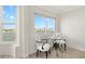 Bright breakfast nook features coastal views, a glass table, and comfortable seating, perfect for casual dining at 174 Golden Gate Pt # 21, Sarasota, FL 34236