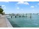 Waterfront dock with boat and picturesque water view at 174 Golden Gate Pt # 21, Sarasota, FL 34236